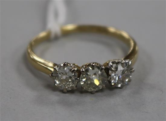 An 18ct gold and three stone diamond ring, size R.